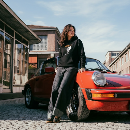 woman leaning on car wearing black jbg ski hoodie