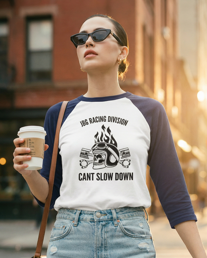 Woman walking on a city street wearing a graphic t-shirt with text and design.