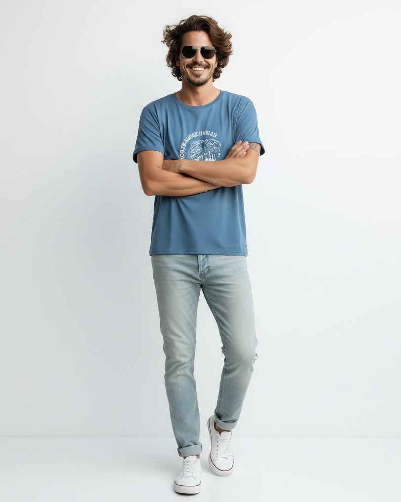 Man wearing a blue t-shirt and light blue jeans with white sneakers on a white background