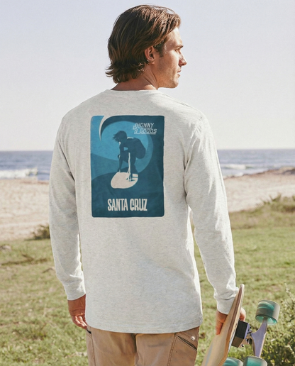 Man wearing a long-sleeve shirt with a graphic design on the beach