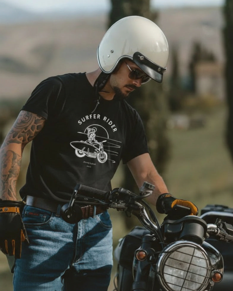 Man on a motorcycle wearing a black t-shirt with 'Surfer Rider' graphic.
