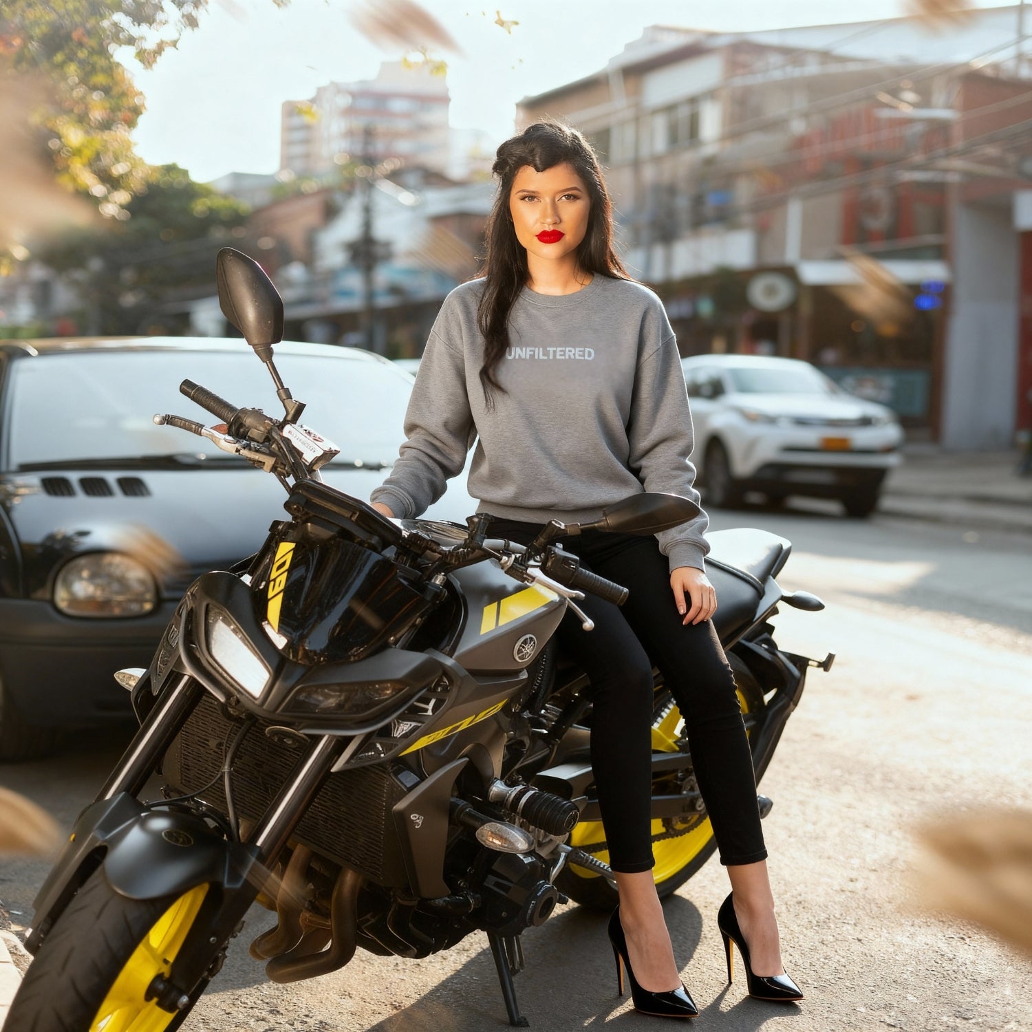 Woman sitting on a motorcycle in an urban setting