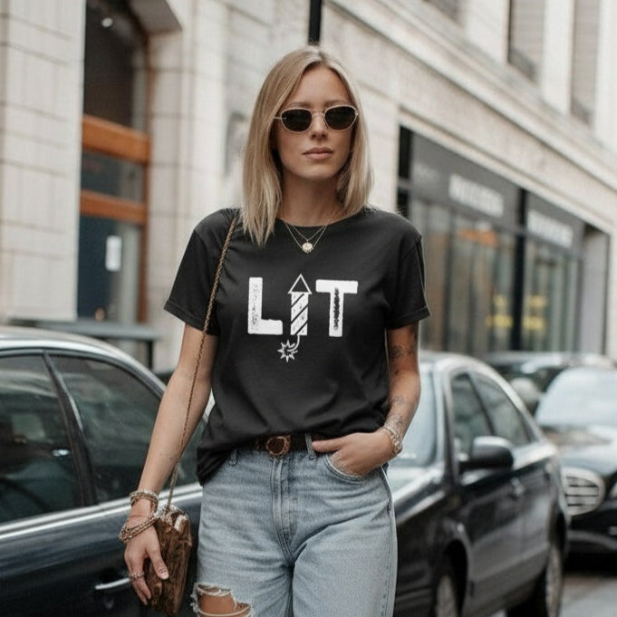 Woman wearing a black t-shirt with 'LIT' text in an urban setting