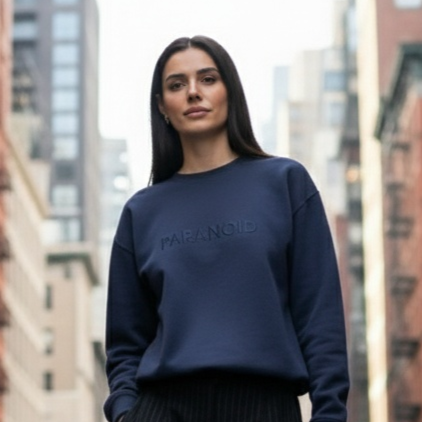 Woman walking on a city street with tall buildings and taxis in the background
