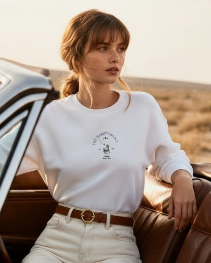 Woman sitting in a convertible car in a desert setting
