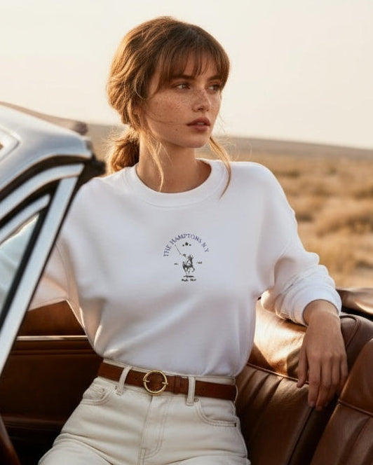 Woman sitting in a convertible car in a desert setting