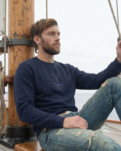 Man sitting on a wooden swing on a ship