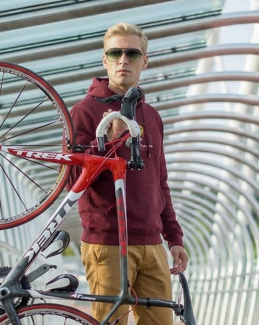 Man carrying a bicycle on a modern architectural bridge