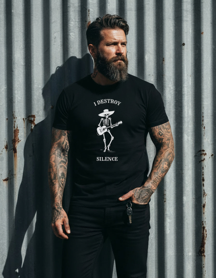 Man wearing a black t-shirt with a graphic design and text, standing against a corrugated metal wall.