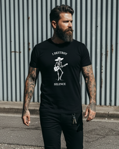 Man wearing a black t-shirt with a graphic design and text, standing against a corrugated metal wall.