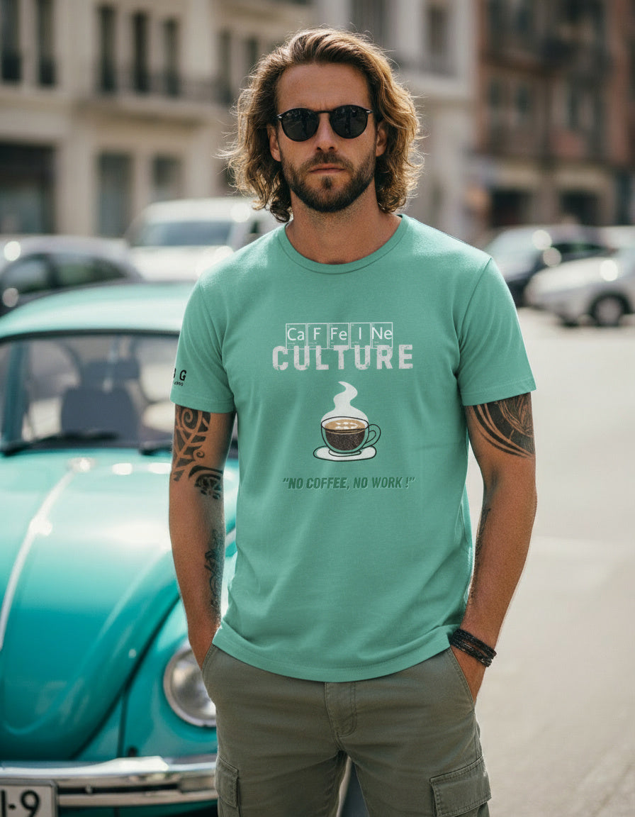 Man wearing a teal t-shirt with a coffee graphic and text, standing in an urban setting.