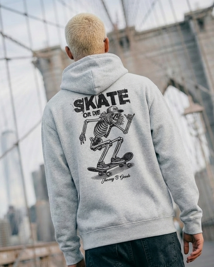 Person wearing a hoodie with a skeleton design on the back, standing on a bridge.