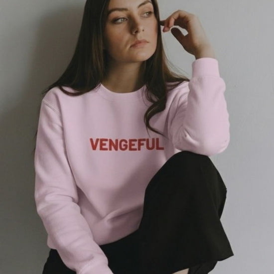 a woman wearing a ping Embroiderd vengeful sweatshirt from JBG
