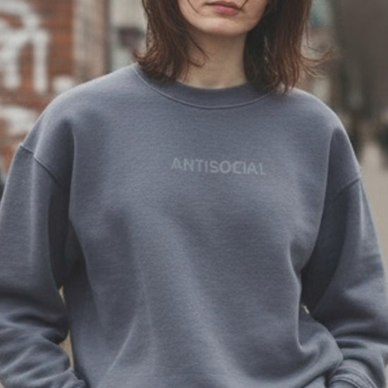 woman wearing anti social embroidered gray sweatshirt from jbg brand