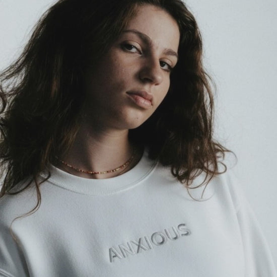 a woman wearing a white Embroidered saying Sweatshirt from JBG Brand