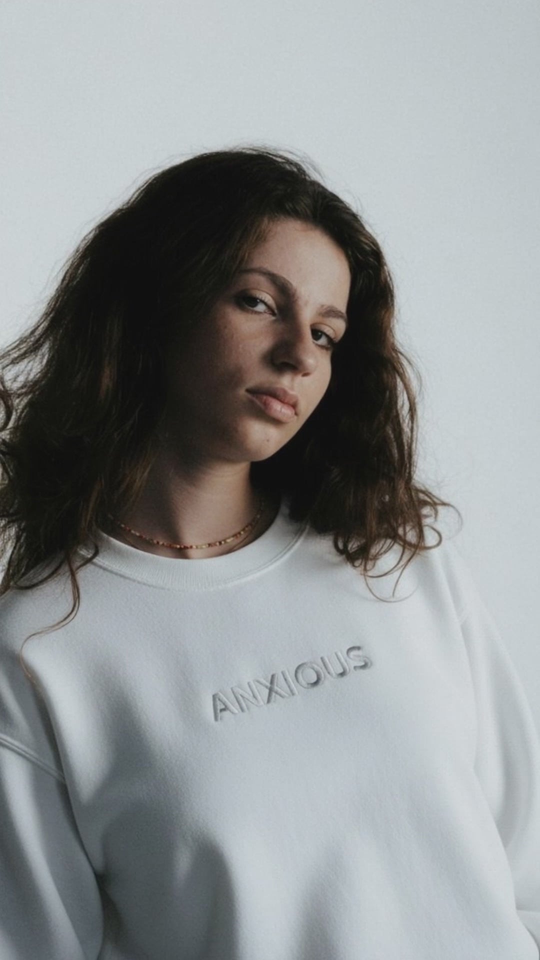 a woman wearing a white Embroidered saying Sweatshirt from JBG Brand